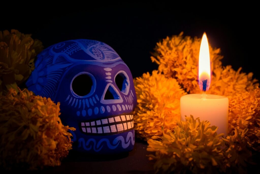 Colorful Catrina and marigolds glowing in candlelight for Día de Muertos celebration.